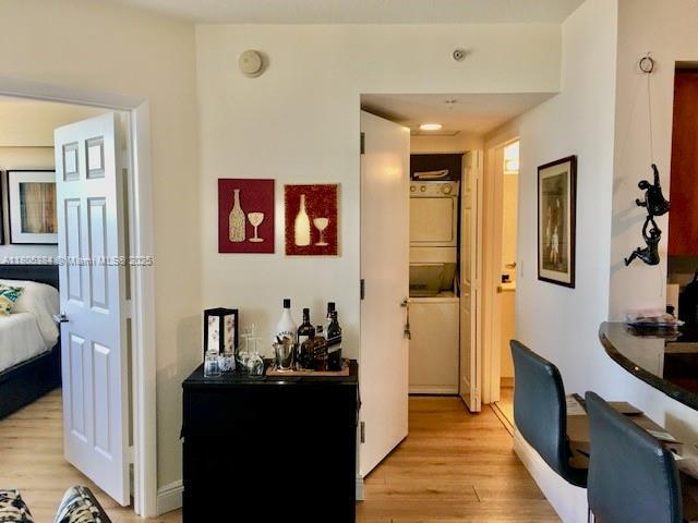 3232 SW 22nd Ter Unit 1303, Miami, FL 33145 - hallway with stacked washing machine and dryer and light wood finished floors