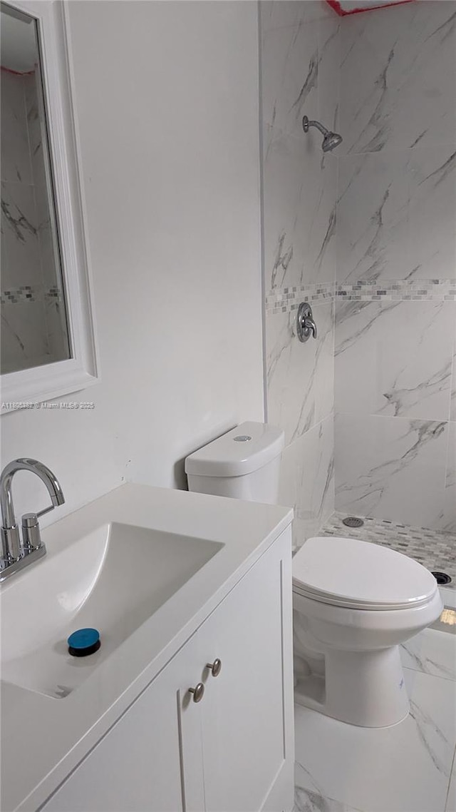 3601 N 72nd Ave, Hollywood, FL 33024 - bathroom featuring marble look tiles, vanity, toilet, and a stall shower