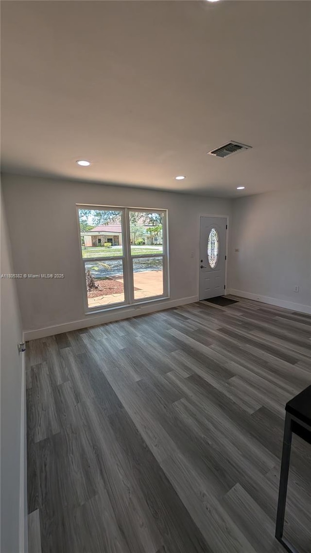 3601 N 72nd Ave, Hollywood, FL 33024 - unfurnished living room featuring baseboards, healthy amount of natural light, dark wood-type flooring, and recessed lighting