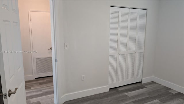 3601 N 72nd Ave, Hollywood, FL 33024 - unfurnished bedroom with a closet, wood finished floors, and baseboards