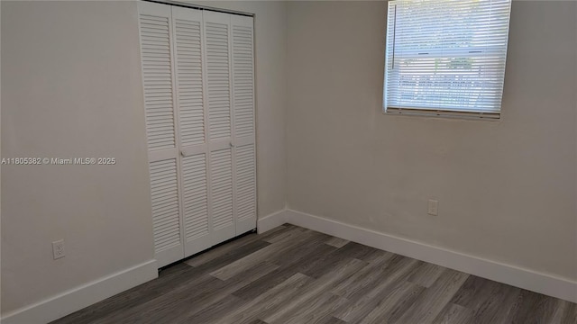 3601 N 72nd Ave, Hollywood, FL 33024 - unfurnished bedroom with a closet, baseboards, and wood finished floors