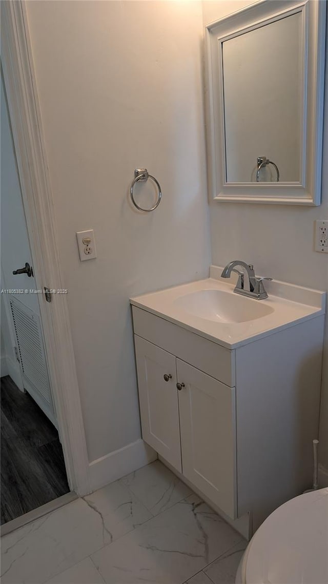 3601 N 72nd Ave, Hollywood, FL 33024 - bathroom featuring vanity, marble look tiles, baseboards, and toilet