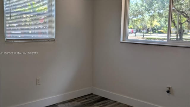 3601 N 72nd Ave, Hollywood, FL 33024 - spare room with baseboards and dark wood-style flooring