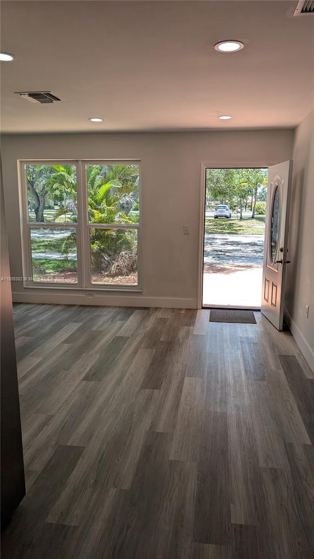 3601 N 72nd Ave, Hollywood, FL 33024 - unfurnished living room featuring baseboards, wood finished floors, and recessed lighting