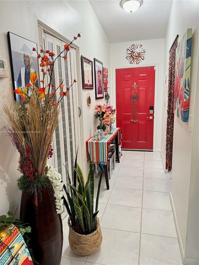 9481 W Elm Ln, Miramar, FL 33025 - entryway featuring a textured ceiling, tile patterned floors, and baseboards