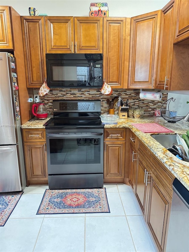 9481 W Elm Ln, Miramar, FL 33025 - kitchen with stainless steel appliances and brown cabinetry