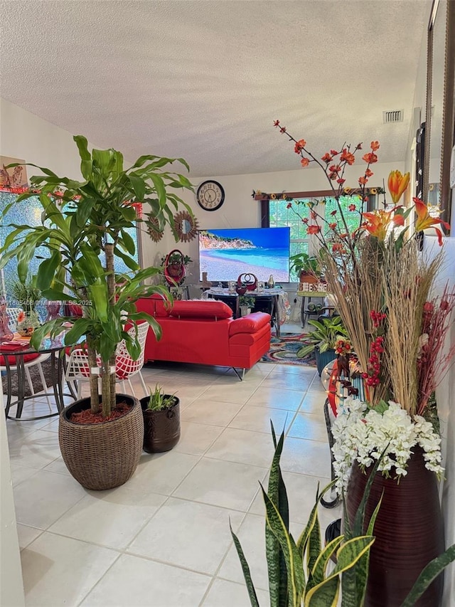 9481 W Elm Ln, Miramar, FL 33025 - tiled living room featuring a textured ceiling