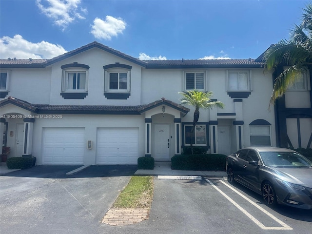 2207 SE 23rd Ave Unit 2207, Homestead, FL 33035 - view of property featuring stucco siding, a tile roof, and a garage