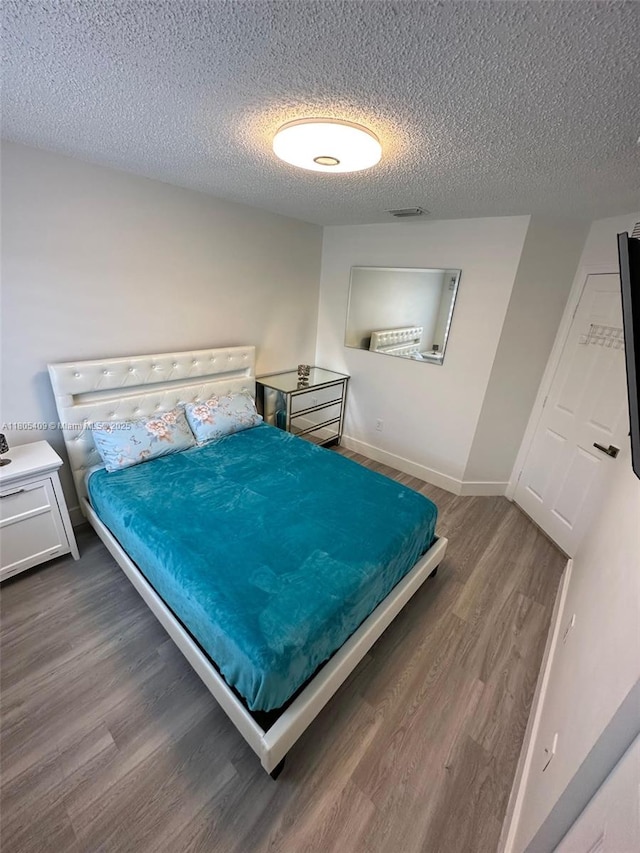 2207 SE 23rd Ave Unit 2207, Homestead, FL 33035 - bedroom featuring wood finished floors, a textured ceiling, and baseboards