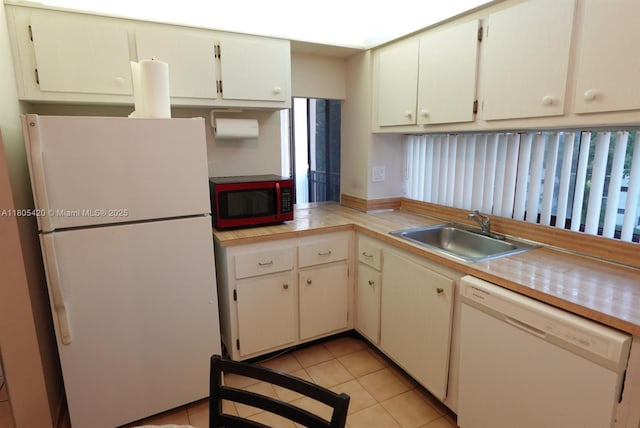 17011 N Bay Rd Unit 408, Sunny Isles Beach, FL 33160 - kitchen featuring white appliances, a sink, light countertops, light tile patterned floors, and white cabinetry