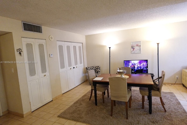 17011 N Bay Rd Unit 408, Sunny Isles Beach, FL 33160 - dining area with light tile patterned flooring, a textured ceiling, and baseboards