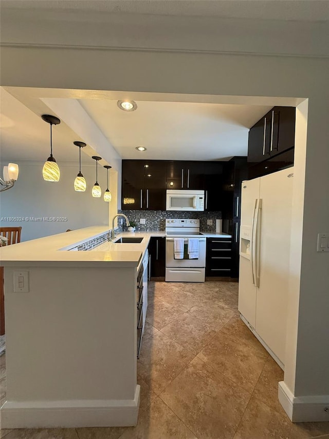 218 NE 12th Ave Unit 503, Hallandale Beach, FL 33009 - kitchen featuring white appliances, a sink, decorative backsplash, a peninsula, and light countertops