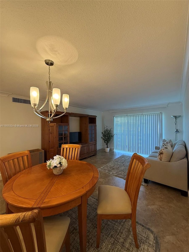 218 NE 12th Ave Unit 503, Hallandale Beach, FL 33009 - dining space with a chandelier, a textured ceiling, and crown molding