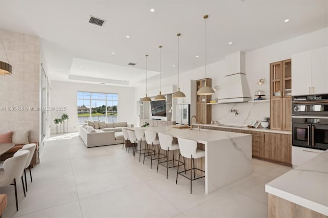 5630 N Sterling Ranch Dr, Davie, FL 33314 - kitchen with open floor plan, a spacious island, modern cabinets, a kitchen bar, and cooktop