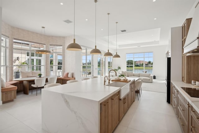 5630 N Sterling Ranch Dr, Davie, FL 33314 - kitchen with open floor plan, a sink, a spacious island, light stone counters, and recessed lighting