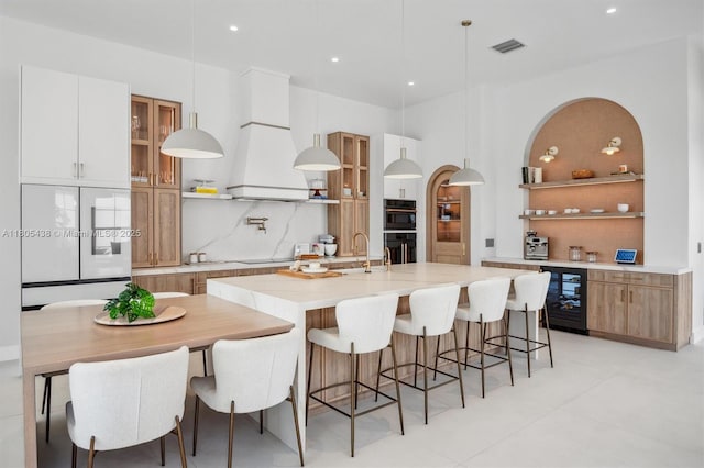 5630 N Sterling Ranch Dr, Davie, FL 33314 - kitchen with wine cooler, tasteful backsplash, open shelves, light countertops, and recessed lighting