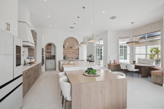 5630 N Sterling Ranch Dr, Davie, FL 33314 - kitchen featuring modern cabinets, custom exhaust hood, white cabinetry, a large island, and recessed lighting
