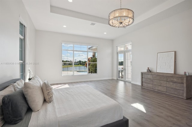 5630 N Sterling Ranch Dr, Davie, FL 33314 - bedroom featuring a chandelier, a raised ceiling, wood finished floors, recessed lighting, and baseboards