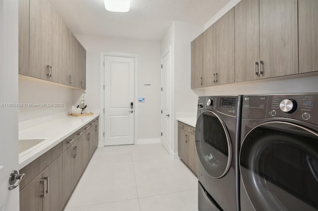 5630 N Sterling Ranch Dr, Davie, FL 33314 - laundry room with washing machine and clothes dryer, cabinet space, light tile patterned flooring, and baseboards