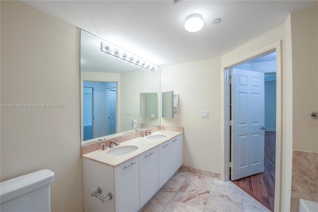 510 NW 84th Ave Unit 303, Plantation, FL 33324 - bathroom featuring toilet, double vanity, marble look tile flooring, and baseboards