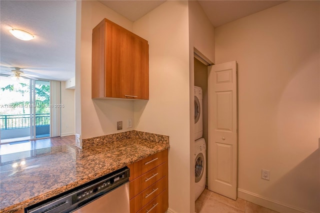 510 NW 84th Ave Unit 303, Plantation, FL 33324 - laundry room with stacked washer and clothes dryer, a ceiling fan, light tile patterned floors, and baseboards