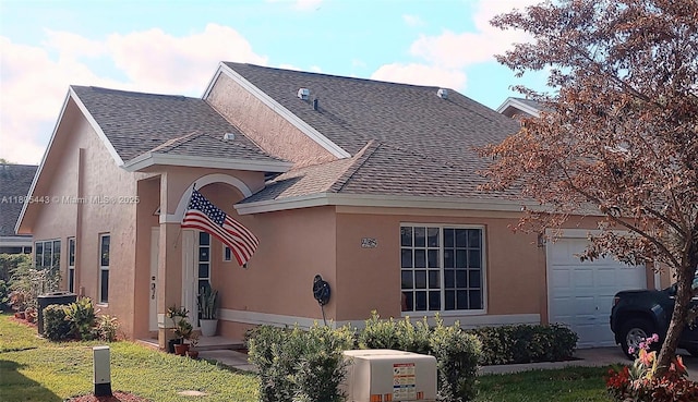 475 SE 20th Ln, Homestead, FL 33033 - view of front facade with a garage, roof with shingles, and stucco siding