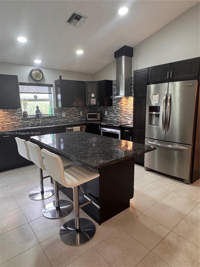 475 SE 20th Ln, Homestead, FL 33033 - kitchen with appliances with stainless steel finishes, range hood, dark cabinets, dark stone countertops, and decorative backsplash