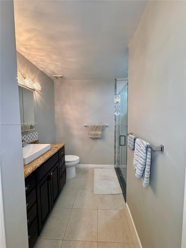 475 SE 20th Ln, Homestead, FL 33033 - full bathroom featuring vanity, a stall shower, tile patterned flooring, toilet, and baseboards