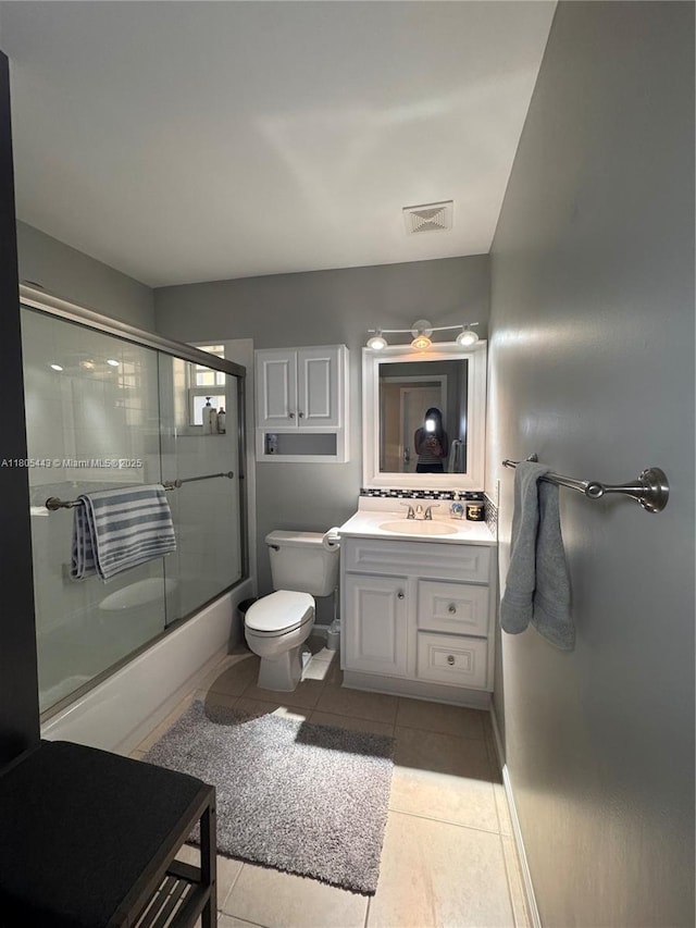 475 SE 20th Ln, Homestead, FL 33033 - bathroom featuring enclosed tub / shower combo, tile patterned flooring, vanity, toilet, and baseboards