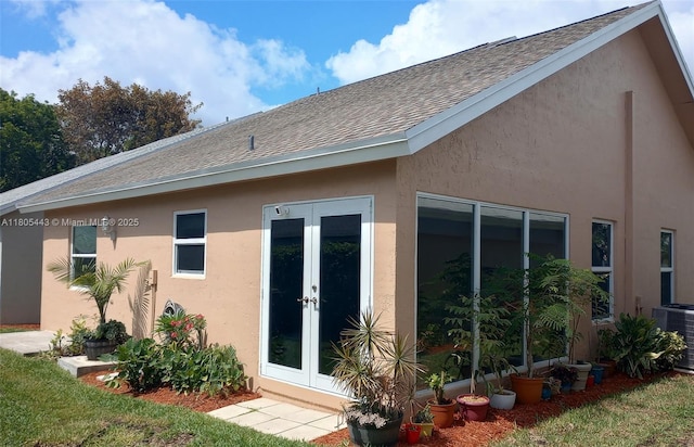 475 SE 20th Ln, Homestead, FL 33033 - back of house with french doors, a shingled roof, stucco siding, and cooling unit