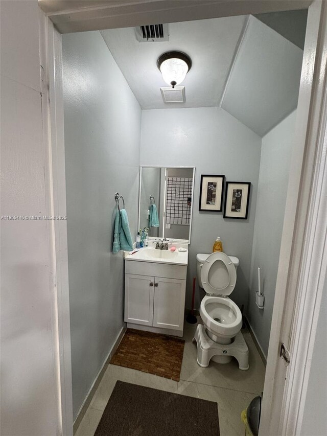7005 NW 173rd Dr Unit 1702, Hialeah, FL 33015 - bathroom with vanity, tile patterned floors, baseboards, lofted ceiling, and toilet