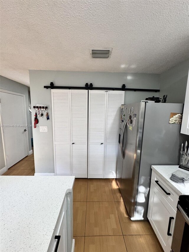 7005 NW 173rd Dr Unit 1702, Hialeah, FL 33015 - kitchen featuring light countertops, white cabinets, stove, and a textured ceiling