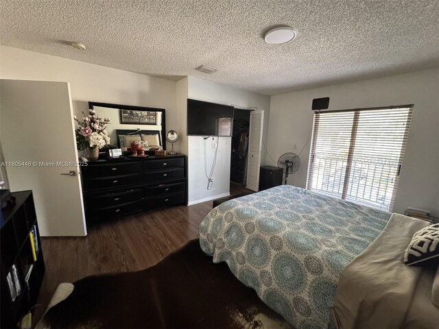 7005 NW 173rd Dr Unit 1702, Hialeah, FL 33015 - bedroom featuring a textured ceiling and dark wood-type flooring