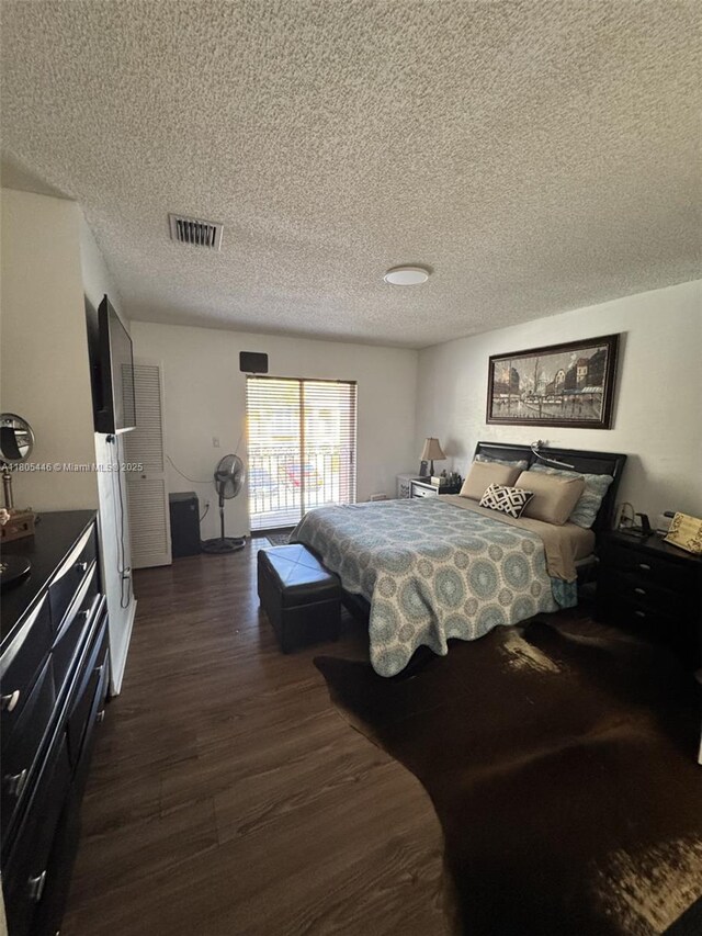 7005 NW 173rd Dr Unit 1702, Hialeah, FL 33015 - bedroom featuring dark wood-type flooring, a textured ceiling, and access to outside