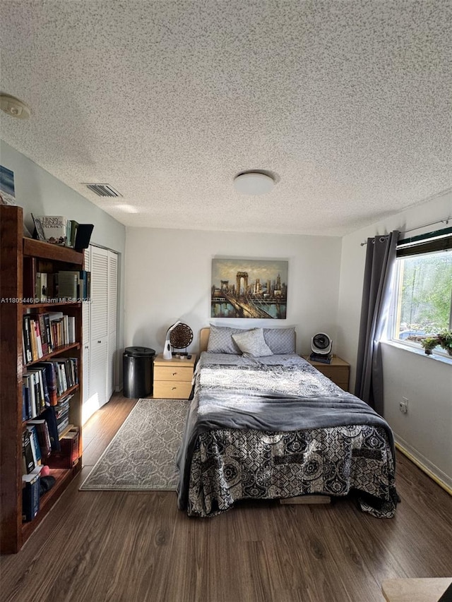 7005 NW 173rd Dr Unit 1702, Hialeah, FL 33015 - bedroom with wood finished floors, a textured ceiling, and baseboards