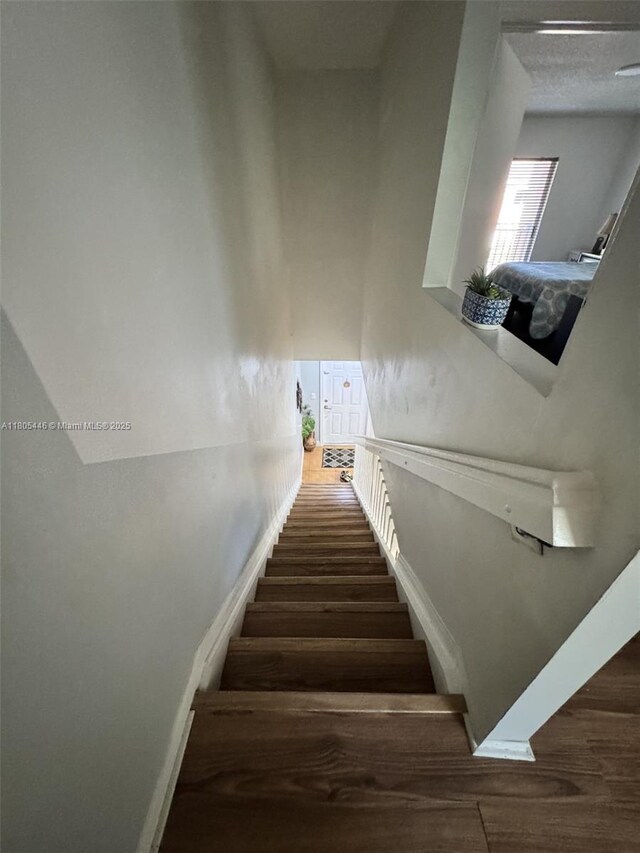 7005 NW 173rd Dr Unit 1702, Hialeah, FL 33015 - stairs featuring wood finished floors and baseboards