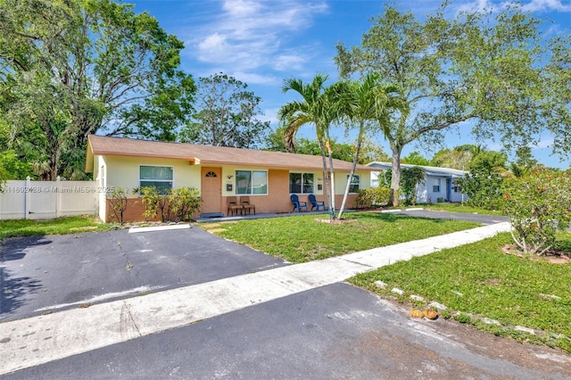 5220-5224 NW 15th Ct, Lauderhill, FL 33313 - view of front of property with brick siding, stucco siding, and asphalt driveway