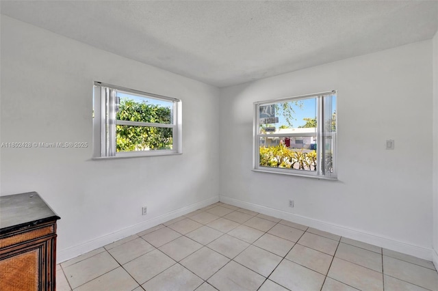 5220-5224 NW 15th Ct, Lauderhill, FL 33313 - spare room featuring baseboards, light tile patterned floors, and a textured ceiling