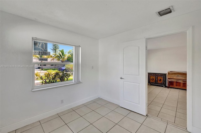 5220-5224 NW 15th Ct, Lauderhill, FL 33313 - empty room featuring light tile patterned floors and baseboards