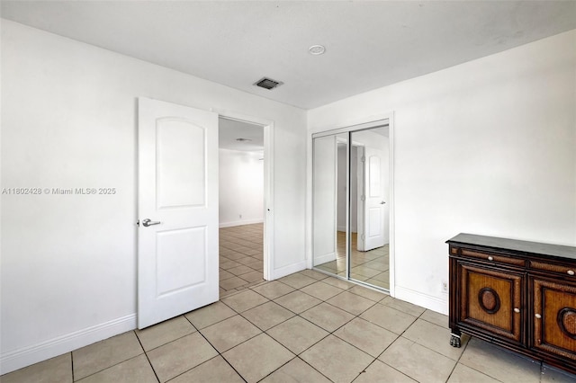 5220-5224 NW 15th Ct, Lauderhill, FL 33313 - unfurnished bedroom with a closet, light tile patterned flooring, and baseboards