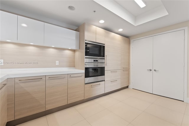 17301 Biscayne Blvd Unit 603, North Miami Beach, FL 33160 - kitchen with stainless steel oven, black microwave, light countertops, modern cabinets, and recessed lighting