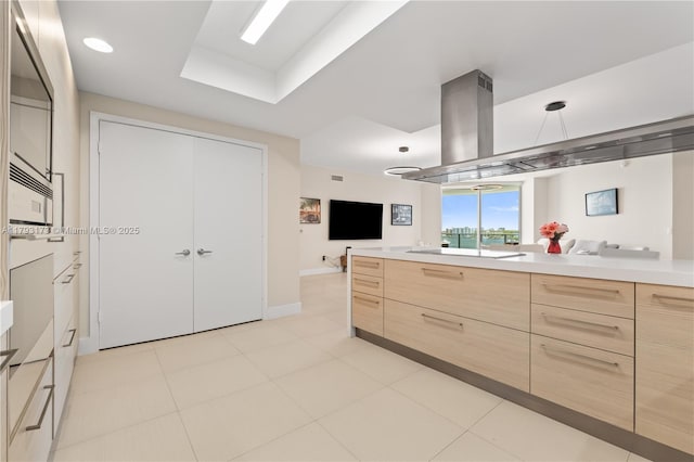 17301 Biscayne Blvd Unit 603, North Miami Beach, FL 33160 - kitchen with light brown cabinetry, modern cabinets, light countertops, open floor plan, and baseboards