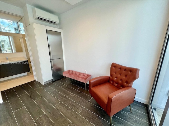 851 NE 1st Ave Unit Caba Pb23, Miami, FL 33132 - sitting room featuring a wall mounted AC, dark wood-style floors, and baseboards