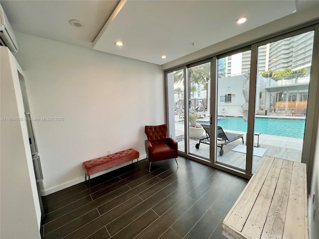 851 NE 1st Ave Unit Caba Pb23, Miami, FL 33132 - doorway to outside with dark wood finished floors, an AC wall unit, baseboards, and recessed lighting
