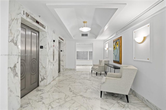 5700 Collins Ave Unit 7G, Miami Beach, FL 33140 - hallway with a raised ceiling, elevator, and marble tiled floors