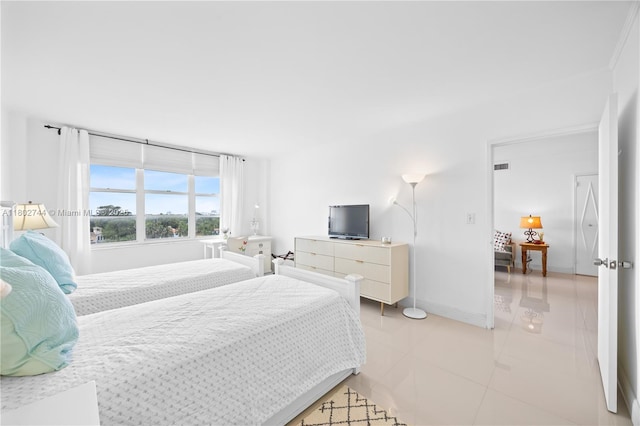 5700 Collins Ave Unit 7G, Miami Beach, FL 33140 - bedroom with light tile patterned floors and baseboards