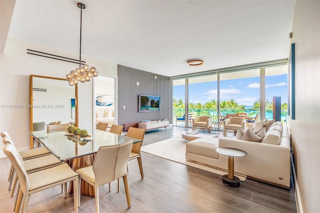 10203 Collins Ave Unit 302, Bal Harbour, FL 33154 - dining space featuring wood finished floors, floor to ceiling windows, and a chandelier