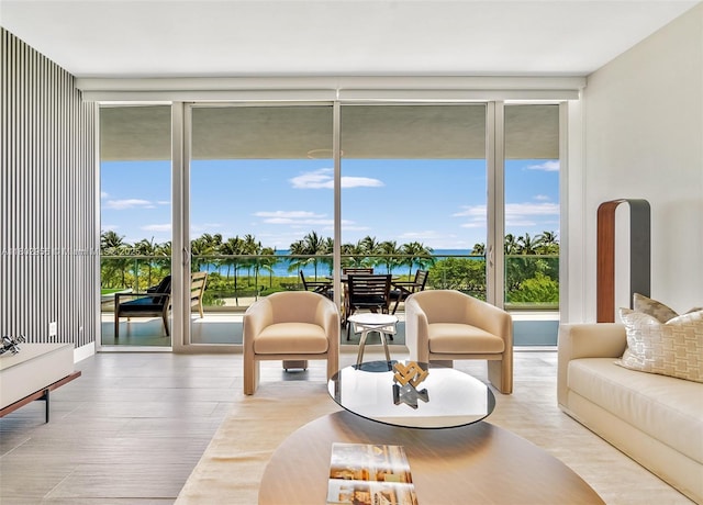 10203 Collins Ave Unit 302, Bal Harbour, FL 33154 - living area featuring a wall of windows, a water view, and wood finished floors