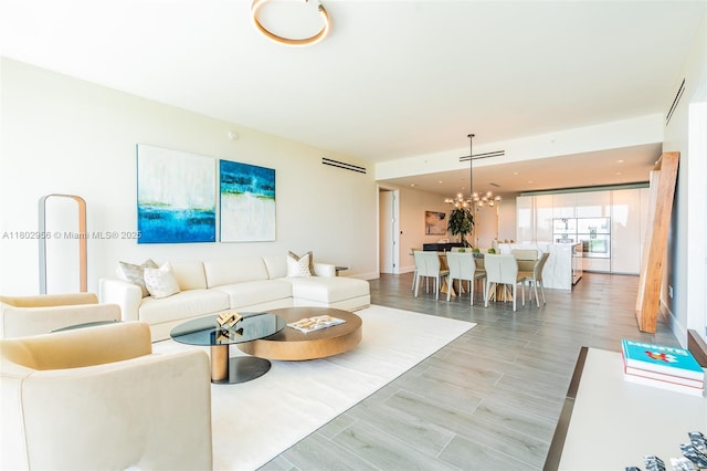 10203 Collins Ave Unit 302, Bal Harbour, FL 33154 - living room featuring a chandelier and light wood-type flooring