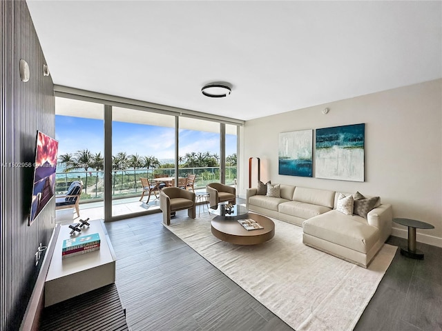 10203 Collins Ave Unit 302, Bal Harbour, FL 33154 - living room with expansive windows, wood finished floors, and baseboards